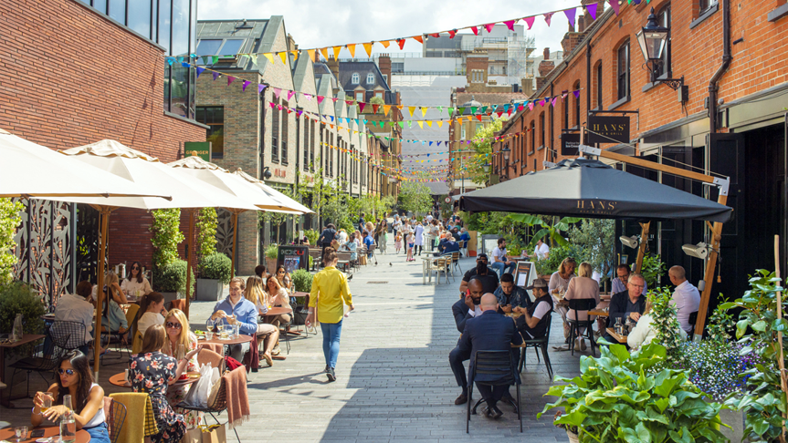 Pavilion Road, London today — a pedestrian street full of outdoor dining, bunting and shoppers
